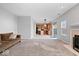 Inviting living area featuring a fireplace, a comfortable sofa, and a view into the kitchen at 10034 Evening Sun Ct, Avon, IN 46123