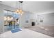 Bright living room with a modern pendant light, fireplace, and sliding glass door to the patio at 10034 Evening Sun Ct, Avon, IN 46123