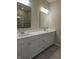 Elegant bathroom with double vanity, quartz countertop and large mirror at 2331 Saddle Dr, Shelbyville, IN 46176
