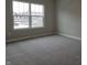 Simple bedroom with gray carpet and a large window at 2331 Saddle Dr, Shelbyville, IN 46176
