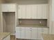 White shaker-style kitchen cabinets and granite countertops at 2331 Saddle Dr, Shelbyville, IN 46176