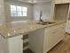 Kitchen island with granite countertop, double sink, and hardwood floor at 2331 Saddle Dr, Shelbyville, IN 46176