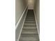 Carpeted staircase with white railing leading to upper level at 2331 Saddle Dr, Shelbyville, IN 46176