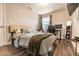 Cozy bedroom featuring a comfortable bed, a workspace, and natural light from a window at 3047 N New Jersey St, Indianapolis, IN 46205