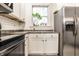 Close-up of kitchen features stainless steel refrigerator and window at 3047 N New Jersey St, Indianapolis, IN 46205