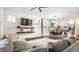 Open-concept living room with modern decor, a large gray sofa, and seamless flow to the kitchen at 3047 N New Jersey St, Indianapolis, IN 46205