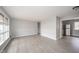 Bright living room with large windows and wood-look flooring and neutral paint at 1827 Lowell Ave, Anderson, IN 46011