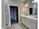 Double vanity bathroom with white cabinets and walk-in closet at 2327 Saddle Dr, Shelbyville, IN 46176