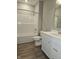 Modern bathroom with a tub, shower, and white vanity at 2327 Saddle Dr, Shelbyville, IN 46176