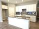 Modern kitchen with white cabinets, granite counters, and island at 2327 Saddle Dr, Shelbyville, IN 46176