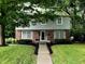 Charming two-story home featuring a landscaped yard and a mix of brick and gray siding facade at 4902 N Capitol Ave, Indianapolis, IN 46208