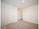 Well-lit bedroom with carpet flooring and ample closet space at 6112 Card Blvd, Indianapolis, IN 46221