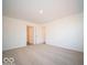 Well-lit bedroom featuring neutral wall paint and carpet at 6112 Card Blvd, Indianapolis, IN 46221