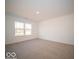 Bright and airy bedroom with neutral carpeting and large window at 6112 Card Blvd, Indianapolis, IN 46221