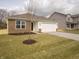 Attractive single-Gathering home with stone detailing, a pristine lawn, and an attached two-car garage at 6112 Card Blvd, Indianapolis, IN 46221