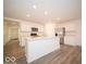 Modern kitchen with island, stainless steel appliances, and vinyl flooring at 6112 Card Blvd, Indianapolis, IN 46221