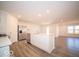 Modern kitchen with island, stainless steel appliances, and vinyl flooring at 6112 Card Blvd, Indianapolis, IN 46221