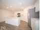 Modern kitchen with island, stainless steel appliances and vinyl flooring at 6112 Card Blvd, Indianapolis, IN 46221