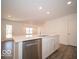 Bright kitchen with white cabinets, quartz countertops, and stainless steel dishwasher at 6112 Card Blvd, Indianapolis, IN 46221