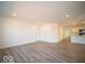 Open living room with vinyl flooring, recessed lighting, and access to kitchen at 6112 Card Blvd, Indianapolis, IN 46221