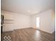 Spacious living room with hardwood floors and an exterior door at 6112 Card Blvd, Indianapolis, IN 46221
