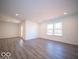 Spacious living area with vinyl flooring, recessed lighting, and exterior access at 6112 Card Blvd, Indianapolis, IN 46221