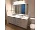 Bathroom featuring double sink vanity with white cabinets, a large mirror, and neutral color scheme at 8010 Philadelphia Dr, Fishers, IN 46038