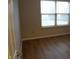 Bedroom with hardwood floors and a large window with blinds at 8010 Philadelphia Dr, Fishers, IN 46038