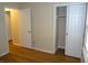 Bedroom with wood flooring, an open closet with sliding doors and multiple entryways at 8010 Philadelphia Dr, Fishers, IN 46038