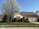 Charming single-Gathering home with a well-manicured lawn and a flowering tree in the front yard at 8010 Philadelphia Dr, Fishers, IN 46038