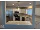Open kitchen featuring white cabinets, stainless steel appliances, and quartz countertops at 8010 Philadelphia Dr, Fishers, IN 46038
