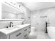 Modern bathroom features double vanity, marble accent wall, freestanding tub, and elegant fixtures at 1015 Churchman Ave, Indianapolis, IN 46203