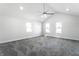 Large, bright bedroom with high ceilings, three windows, and neutral gray carpet flooring at 1015 Churchman Ave, Indianapolis, IN 46203