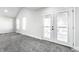 Bright bedroom with multiple windows, French doors, neutral carpet, and natural light at 1015 Churchman Ave, Indianapolis, IN 46203