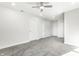 Spacious bedroom with soft gray carpet, multiple closets, and a ceiling fan for comfort at 1015 Churchman Ave, Indianapolis, IN 46203