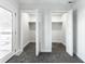 Dual closets with open doors reveal shelving and carpeted floors for convenient storage at 1015 Churchman Ave, Indianapolis, IN 46203
