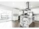 Well-equipped kitchen with white cabinets, stainless steel appliances, granite counters, and access to an outdoor deck at 1015 Churchman Ave, Indianapolis, IN 46203