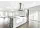 Open-concept kitchen with a large center island, stainless steel vent hood, and view into the living room at 1015 Churchman Ave, Indianapolis, IN 46203