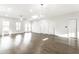 Bright living space with wood-look floors and views of entry doors and windows filling the space with natural light at 1015 Churchman Ave, Indianapolis, IN 46203