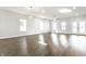 Bright living space with wood-look floors and views of entry doors and windows filling the space with natural light at 1015 Churchman Ave, Indianapolis, IN 46203