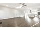 Open-concept living space with wood-look floors leading to modern white kitchen and stainless appliances at 1015 Churchman Ave, Indianapolis, IN 46203