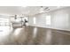 Open-concept living space with wood-look floors leading to modern white kitchen and stainless appliances at 1015 Churchman Ave, Indianapolis, IN 46203