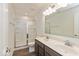 Bathroom featuring double sink vanity, modern fixtures, and shower with glass doors at 1105 Gatewick Ct, Greenwood, IN 46143