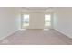 Bright bedroom features plush carpeting, recessed lighting, and two windows allowing natural light at 1105 Gatewick Ct, Greenwood, IN 46143