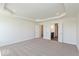 Spacious bedroom with tray ceilings, plush carpets, and white doors to ensuite bathroom and closets at 1105 Gatewick Ct, Greenwood, IN 46143