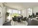 Bright dining area features a modern chandelier, large windows, and stylish furnishings overlooking a spacious backyard at 1105 Gatewick Ct, Greenwood, IN 46143