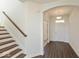 Inviting entryway featuring hardwood floors, stairs with wood railing, and an arched doorway at 1105 Gatewick Ct, Greenwood, IN 46143