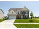 Charming two-story brick home with a well-manicured lawn and attached two-car garage at 1105 Gatewick Ct, Greenwood, IN 46143