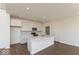 Modern kitchen featuring a large island, white cabinets, and stainless steel appliances at 1105 Gatewick Ct, Greenwood, IN 46143
