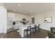 Modern kitchen boasts white cabinets, stainless steel appliances, a large island, and breakfast bar seating at 1105 Gatewick Ct, Greenwood, IN 46143